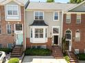 Charming townhouses feature brick facades, well-manicured landscaping, and inviting entrances at 6809 Middleboro Dr Dr, Raleigh, NC 27612