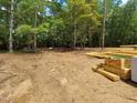 A cleared lot shows lumber ready to be used in construction on a wooded lot at 8916 Thompson Mill Rd, Wake Forest, NC 27587