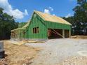 New home under construction with Zip System sheathing, wood framing, and gravel driveway at 8920 Thompson Mill Rd, Wake Forest, NC 27587