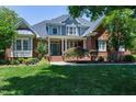 Beautiful two-story brick home with a well-maintained lawn and inviting front entrance at 9048 Chelsea Dr, Raleigh, NC 27603
