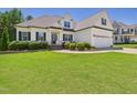 Well-maintained home featuring a neatly landscaped yard and classic architectural details at 100 S Sunset Ridge Dr, Willow Springs, NC 27592