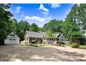 Beautiful home featuring lush landscaping and a spacious driveway leading to a detached two-car garage and shed at 10031 Old Middlesex Rd, Middlesex, NC 27557