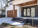 Covered front porch with a wood ceiling and supporting posts, leading to double glass front doors at 1009 Parker St, Raleigh, NC 27607