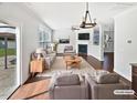 Bright living room with a fireplace, ceiling fan, and sliding doors to the outdoor living space at 1092 Adams Point Dr, Garner, NC 27529