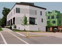 Modern townhome exterior with white brick, large windows, and landscaping at 1301 Chamblee Hill Ct, Raleigh, NC 27608