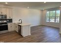 The kitchen flows into the living space and includes stainless steel appliances and a center island at 1563 Wendell Valley Blvd, Wendell, NC 27591