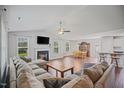 Spacious living room with hardwood floors, fireplace, and an abundance of natural light at 174 Arrow Ln, Middlesex, NC 27557