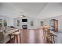 Open-concept living area featuring a fireplace, hardwood floors, and large windows at 174 Arrow Ln, Middlesex, NC 27557