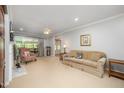 Spacious living room with neutral walls, fireplace, ceiling fan, and ample natural light from large windows at 1822 Atterbury Ln, Durham, NC 27712