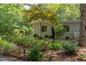 Sculpted landscaping with a statue enhances this modern home's exterior at 1908 S Lakeshore Dr, Chapel Hill, NC 27514