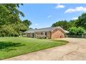 Well-maintained brick home with a spacious driveway and lush green lawn at 2119 Northcrest Dr, Elon, NC 27244