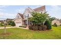 Well-maintained home featuring a two-car garage, brick facade, and landscaped front yard at 265 Beckwith Ave, Clayton, NC 27527