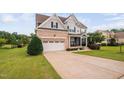 Attractive two-story home with brick accents, two-car garage, and inviting front lawn at 265 Beckwith Ave, Clayton, NC 27527
