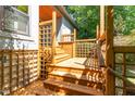 A wood deck with lattice offers access to the home at 28 Benchmark, Pittsboro, NC 27312