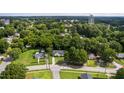 An aerial view of a charming home nestled among lush greenery in a peaceful neighborhood at 308 E Gilbreath St, Graham, NC 27253
