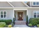 Inviting front door with a 'Welcome' sign and lovely landscaping at 308 Nashville Dr, Archer Lodge, NC 27527