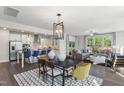 Open concept living space with white cabinets and stainless steel appliances throughout the kitchen at 335 Augusta Pond Way # 174, Raleigh, NC 27603