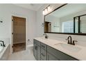 Bright bathroom featuring a double vanity, sleek fixtures, and a well-organized walk-in closet at 343 Augusta Pond Way # 176, Raleigh, NC 27603