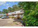 Desirable townhomes feature neutral siding, private entrances with wood stairs, and dedicated parking at 3622 Colchester St # 17, Durham, NC 27707