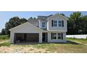 Charming two-story home features a two-car garage, gray siding, black roof, and dark brown window shutters at 3881 Josiah Ct, Nashville, NC 27856