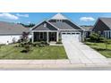 Charming exterior features a stone facade, gray siding, and a well-manicured lawn at 405 Bramble Ln, Clayton, NC 27527