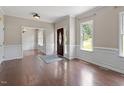 Bright and airy living room with beautiful hardwood floors, white trim and wainscoting at 4733 Royal Troon Dr, Raleigh, NC 27604