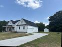 Beautiful new construction home featuring a large yard and concrete driveway at 50 Leah Ln, Louisburg, NC 27549