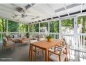 Comfortable screened porch with an outdoor dining set and a seating area perfect for entertaining at 5124 Lazywood Ln, Durham, NC 27712