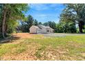 Well-kept home exterior featuring a manicured lawn and gravel driveway at 7082 Cornwall Rd, Oxford, NC 27565