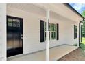Inviting front porch with a stylish black front door and visible house number at 7082 Cornwall Rd, Oxford, NC 27565