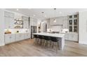 Spacious eat-in kitchen with an oversized island, modern stainless appliances and light gray cabinetry at 7304 Wexford Woods Ln, Wake Forest, NC 27587