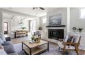 Cozy living room with a fireplace, comfortable seating, and an adjacent dining area at 812 Ballaster Rd, Fuquay Varina, NC 27526