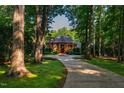 Brick home nestled among mature trees, offering privacy and curb appeal at 8200 Bromley Rd, Hillsborough, NC 27278