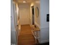 Entry hallway featuring hardwood floors, white trim, and access to the main living areas at 908 Valmet Dr, Durham, NC 27703