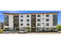 Attractive modern condo building featuring balconies and professional landscaping at 105 Chatham Walk Ln # 304, Cary, NC 27511