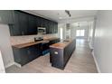 Modern kitchen with dark cabinetry, butcher block countertops, and stainless steel appliances at 109 N Dunn St, Angier, NC 27501