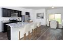 Modern kitchen features stainless steel appliances, granite countertops, and a breakfast bar with seating at 1209 Solace Way, Rolesville, NC 27571