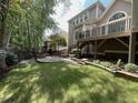 Spacious backyard featuring a stone fire pit, tiered patio and green lawn perfect for outdoor entertaining at 1316 Plunket Dr, Wake Forest, NC 27587