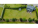 Large backyard with lush lawn, shed, privacy trees, and rear house view at 192 Waterpine Dr, Garner, NC 27529