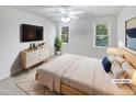 Serene bedroom featuring neutral walls, a ceiling fan, and natural light from the dual windows at 2408 Tiltonshire Ln, Apex, NC 27539