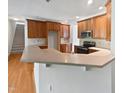 Open kitchen design with bar seating and easy access to other living spaces at 2408 Tiltonshire Ln, Apex, NC 27539