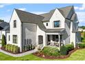 Angle of the home shows the light colored brick and landscaping at 241 Teague St, Wake Forest, NC 27587