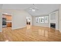 Cozy living room boasting hardwood floors, fireplace, bright windows, and open access to the kitchen at 276 Sagamore Dr, Louisburg, NC 27549