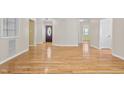 Spacious room featuring beautiful hardwood floors with a view of the front door at 276 Sagamore Dr, Louisburg, NC 27549