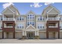 Attractive multi-story condo building featuring garages, balconies, and a welcoming entrance under a clear sky at 2810 Bedford Green Dr # 5, Raleigh, NC 27604