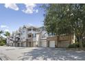 A row of multi-story condominium buildings with garages and balconies on a sunny day at 2810 Bedford Green Dr # 5, Raleigh, NC 27604