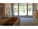 Bright kitchen featuring a large window, unfinished wood cabinetry, and abundant natural light during renovations at 3004 William Frederick Way, Raleigh, NC 27603
