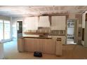 Bright, unfinished kitchen featuring stylish white cabinets, a large island, and ample storage space during renovations at 3004 William Frederick Way, Raleigh, NC 27603