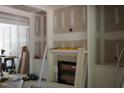 Unfinished living room showcasing fireplace with custom trim, built-in cabinets, and a cozy atmosphere during renovations at 3004 William Frederick Way, Raleigh, NC 27603