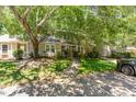 Inviting exterior view showcasing the home's landscaping and curb appeal, shaded by mature trees at 303 Applecross Dr, Cary, NC 27511